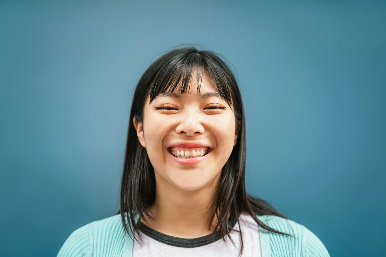 Portrait of young Asian girl smiling at camera